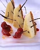 Three pieces of American cheesecake with raspberry sauce