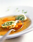 Vegetable broth with pancake and spinach rolls