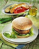 Hamburger with cucumber slices and lettuce leaves