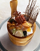 Sashimi of mixed fish in wooden pot