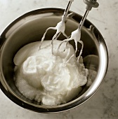 Beating egg white stiffly with an electric hand beater