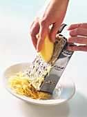 Grating raw potato with four sided grater