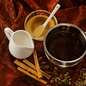 Yogi tea (Ayurvedic spiced tea), milk and honey beside it