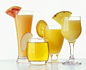 Four different fruit juices in glasses