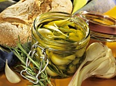 Garlic with rosemary in olive oil in a jar