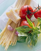 Still life with spaghetti, tomatoes, basil & parmesan
