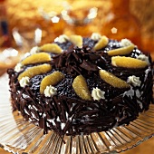 Chocolate cream gateau with blackberry icing & orange segments