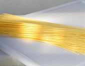 Spaghetti on a white chopping board
