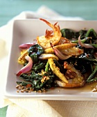 Asian pan-cooked spinach dish with baby corn cobs and shrimps