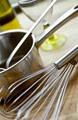 Egg whisk and casserole with ladle