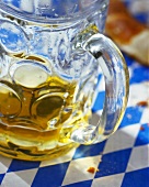 Beer in tankard and pretzel on table (Bavaria, Germany)