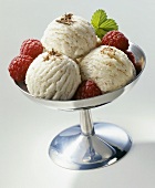 Almond ice cream, garnished with raspberries & mint leaves