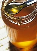 Honey in jar and on spoon