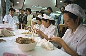 Chinese women making pasties (Shanghai)