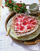 Heart-shaped yoghurt & cherry gateau with grated chocolate
