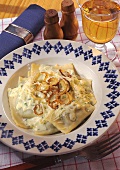 Pasta parcels with quark & spinach filling in cheese sauce