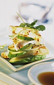 Marinated tofu slices with sesame and cucumber slices