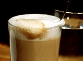 Latte macchiato, a glass of water behind