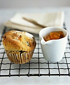 Fruit muffin and a pot of apricot jam