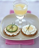 Two pumpernickel snacks and a glass of grapefruit juice