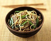 Asian egg noodles with beef and mangetouts