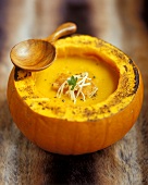 Cream of pumpkin soup in hollowed-out pumpkin 