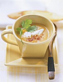 Pumpkin soup with sour cream, coriander, chili powder