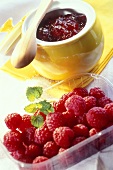 Raspberry jam and a dish of fresh raspberries