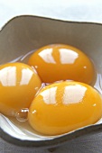 Three egg yolks in dish