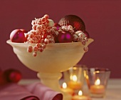 Glass bowl of berries & Christmas baubles as table centre