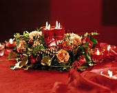 Advent arrangement: roses, gold threads & burning candles