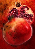 Artistic still life with whole and half pomegranate