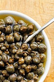 Pickled capers in a white bowl