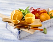 Peeled oranges on wooden board with peppermint
