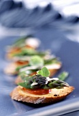 Crostini (Toasted bread with green asparagus and tomatoes)