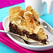 Piece of chocolate pear cake with strudel pastry