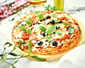 Pizza with vegetables, ham and cheese