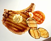 Barbecued pork cutlet with herb butter & barbecued vegetables