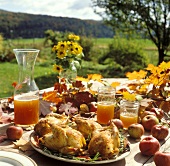 Roast chicken on autumnal table (outdoor shot)