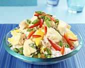 Rice salad with peppers, cooked curried chicken & mango wedges