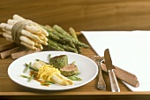 Veal fillet in herb coating with noodles and asparagus