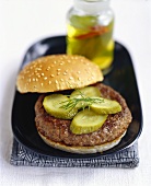 Spicy burger with pickled gherkins