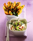 Potato wedges with herbs & radishes & cucumber in sour cream