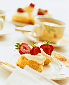 Scones with strawberries and cream and a cup of tea