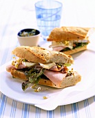 Baguette sandwich with Brie, boiled ham and sprouts