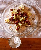 Star cake decorated with cherries and star fruit