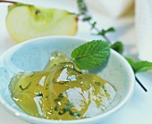 Bowl of apple juice jelly with mint