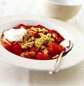 Strawberry and pistachio crumble with double cream