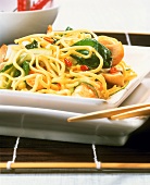 Egg noodles with chili peppers, chicken and spinach