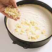 Decorating a cake with flaked almonds
